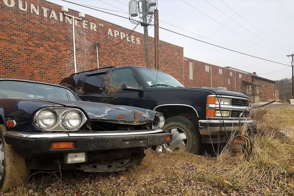 Rusted cars outside an abandoned fruit processing plant in Paw Paw, West Virginia in the United States.