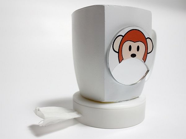 A mug with an embedded mirror and tissue dispenser for kids to clean off milk moustaches.