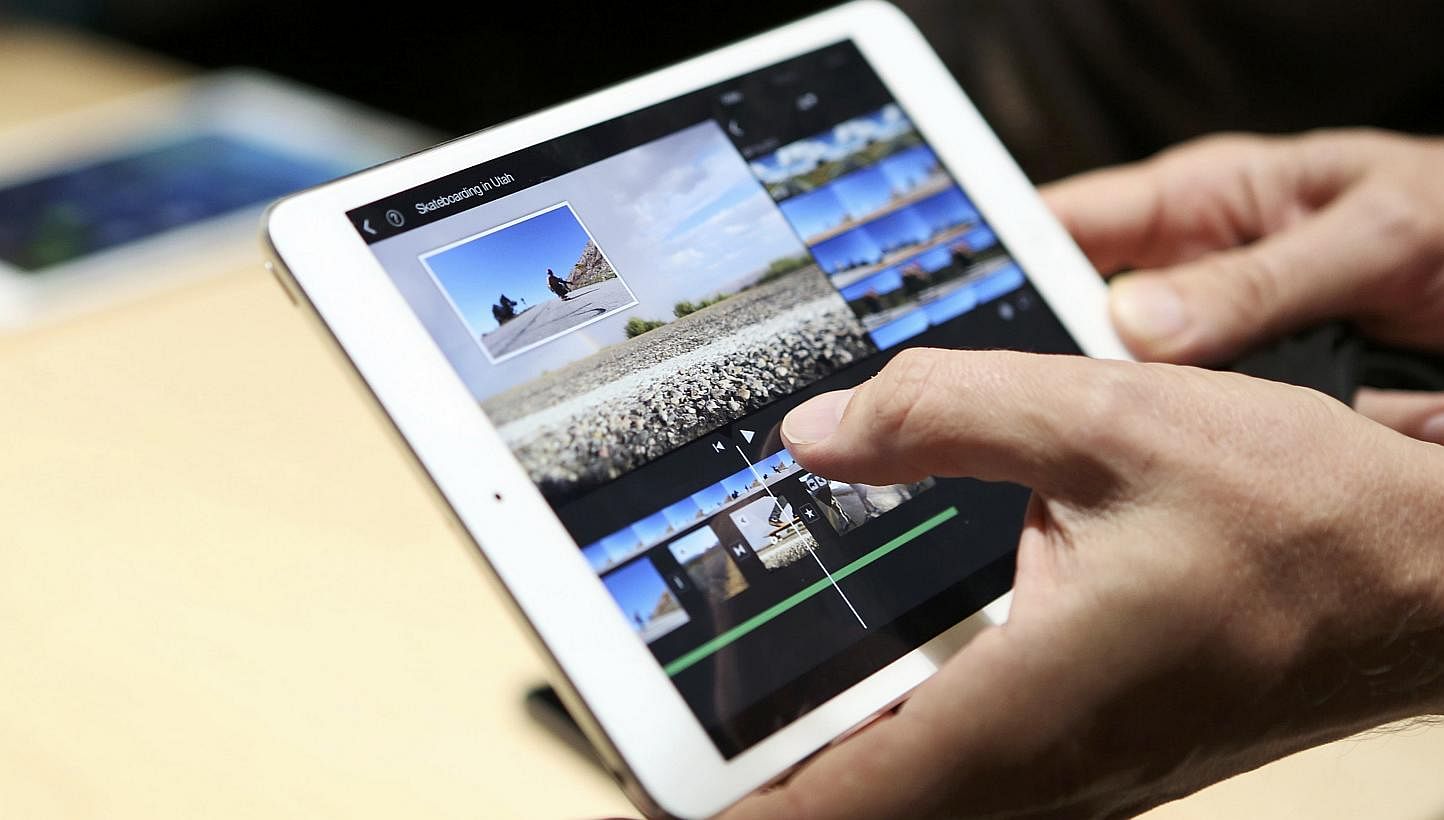A member of the media holds the new iPad mini with Retnia display during an Apple event in San Francisco, California on Oct 22, 2013.&nbsp;Apple's latest iPad mini with Retina display is now available in Singapore. It can be ordered via the tech gian