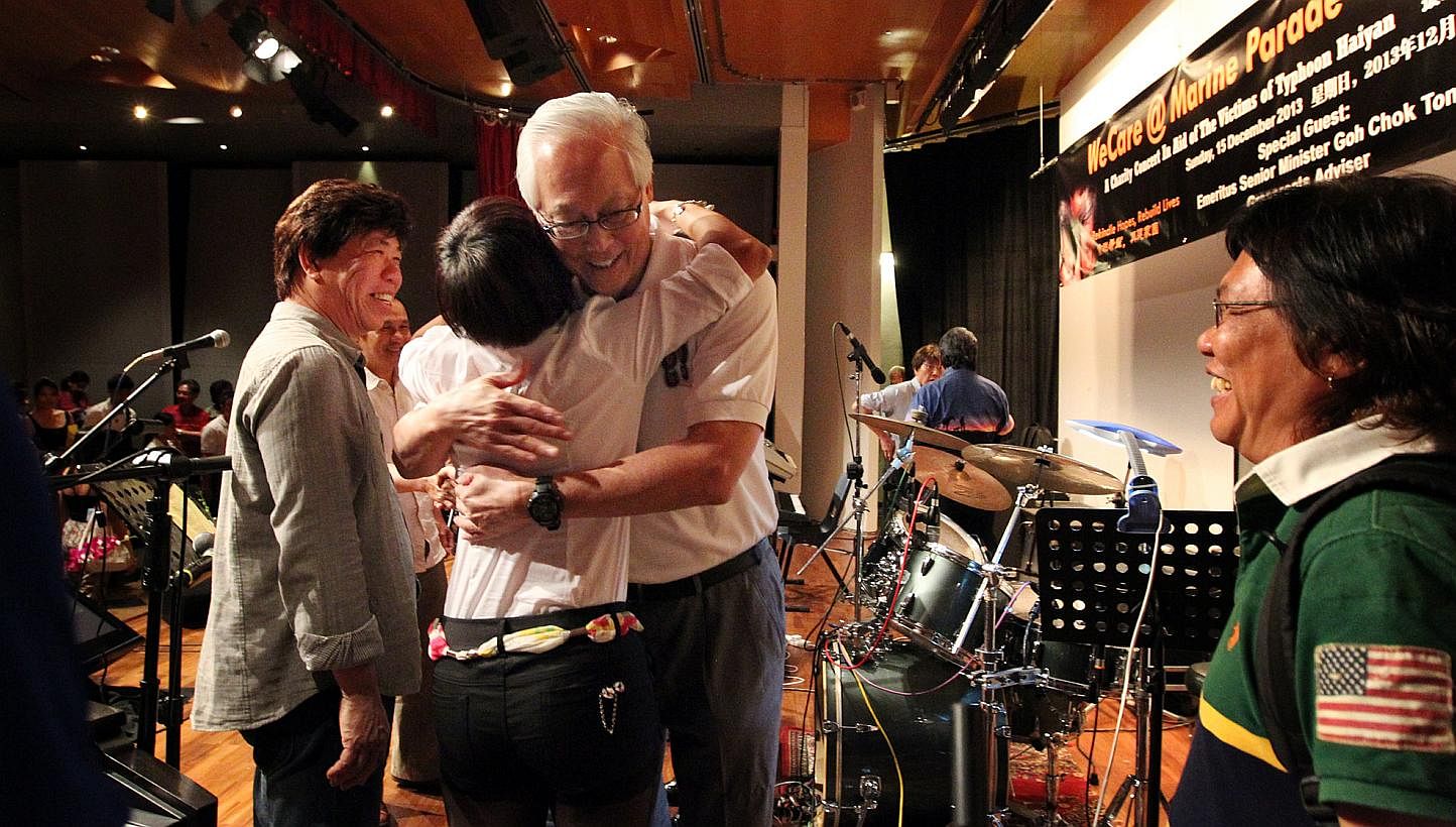 ESM Goh Chok Tong congratulating Ms Anne Koh, 47, and other performers at the Marine Parade Community Club who took part yesterday in a charity concert for victims of Typhoon Haiyan.