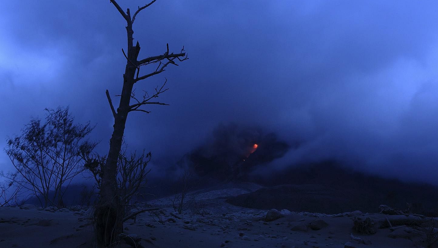 Pyroclastic flow glows red during the eruption of Mt Sinabung near Sigarang Garang village in Karo district, Indonesia's North Sumatra province, Jan 19, 2014. More than 28,000 villagers have been evacuated since authorities raised the alert status fo