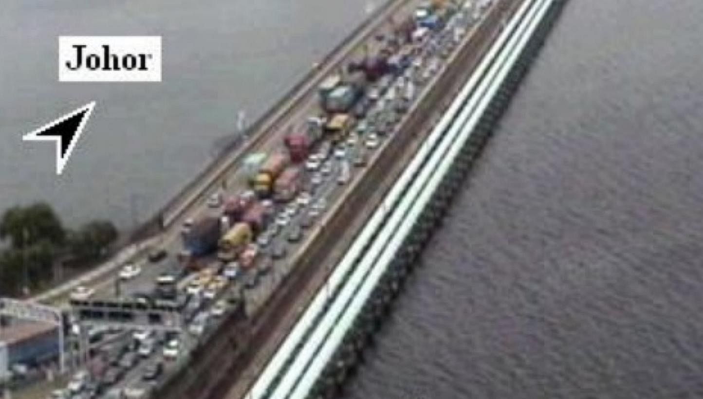 Singapore-bound traffic on the Causeway was crawling at noon on Wednesday, a day after police and immigration authorities said a Malaysian woman motorist managed to sneak into Singapore at the checkpoint by tailgating a vehicle. -- SCREENGRAB: ONEMOT