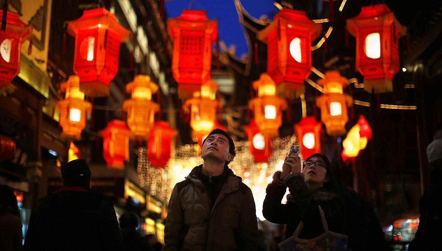 &nbsp;A couple look at Chinese New Year lanterns decorating Yuyuan Garden in downtown Shanghai January 28, 2014.&nbsp; As the Chinese New Year comes around, a difficult question arises for couples: which set of parents to join for the all-important r