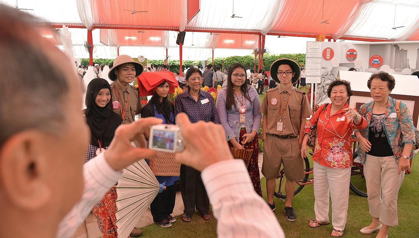 Guests at the Pioneer Generation Tribute event at the Istana on Feb 9, 2014, take pictures with people dressed as pioneers from early Singapore. The much-anticipated package for Singapore's pioneer generation will give this group assistance with thei