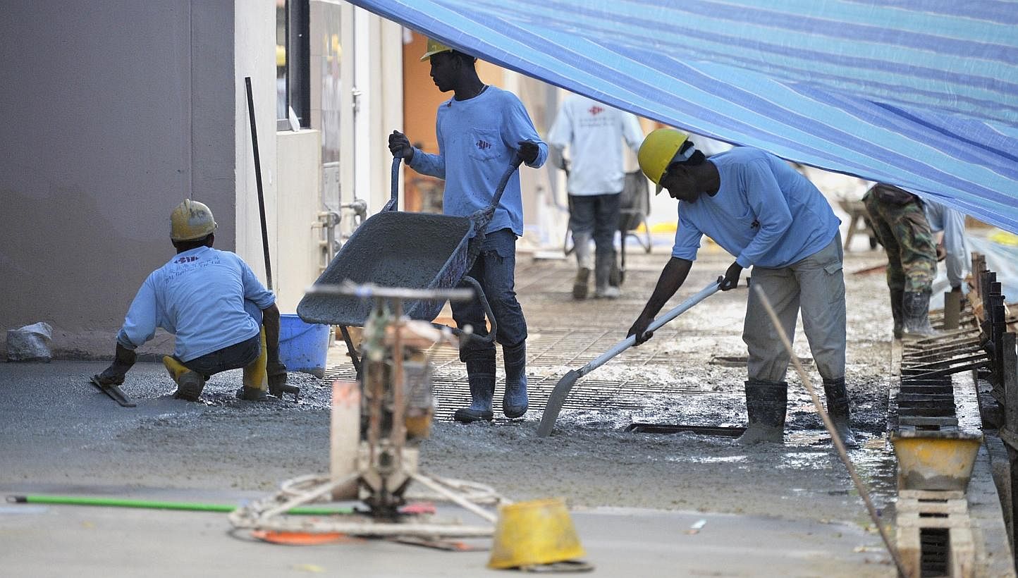 Construction workers in Chai Chee on Jan 14, 2014. The levy on foreign construction workers with only basic skills will go up from $600 per worker to $700 in July 2016, said Finance Minister Tharman Shanmugaratnam. -- ST FILE PHOTO: MATTHIAS HO