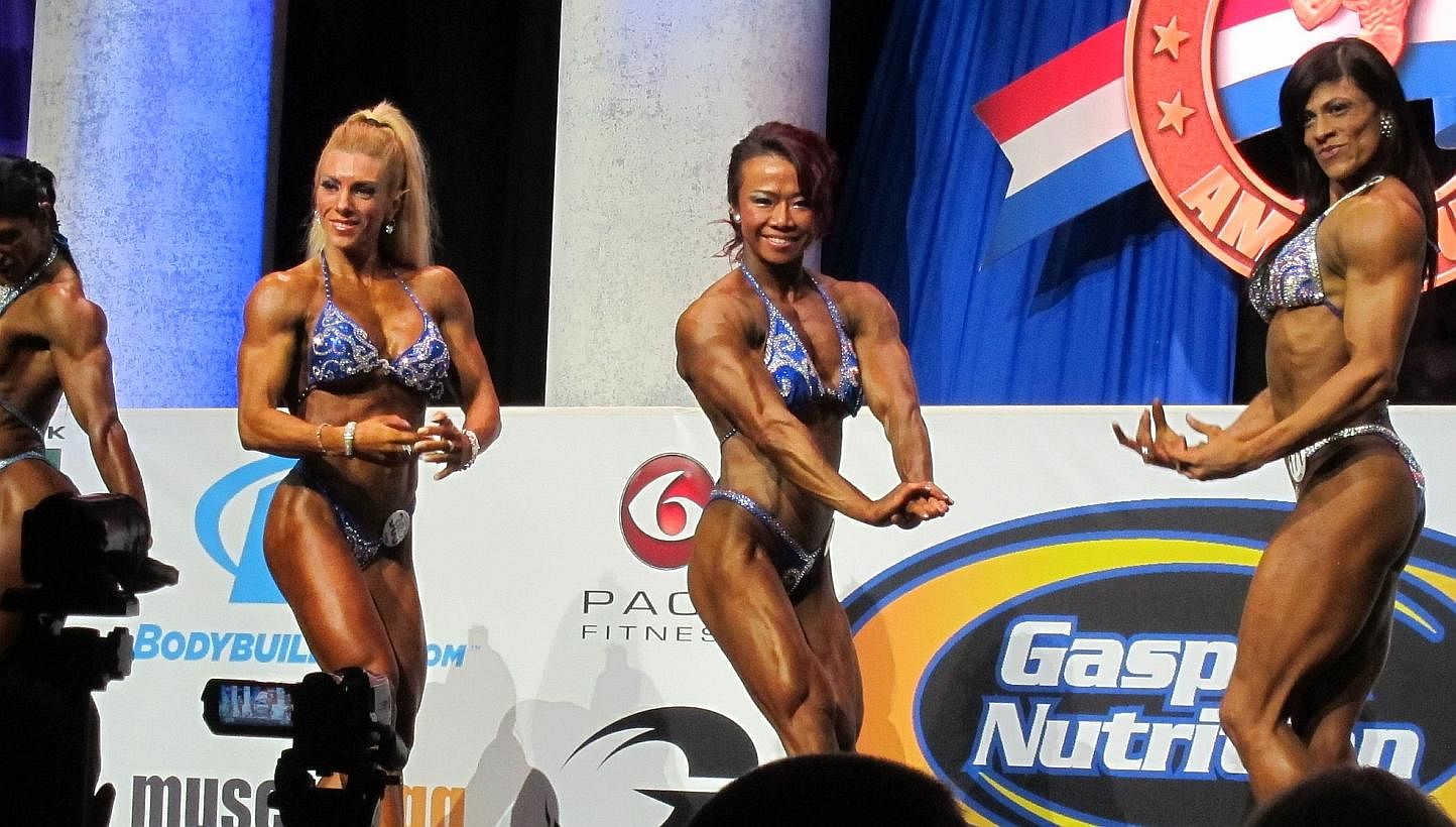 Singapore bodybuilder Joan Liew (centre) came out tops in the Women's Physique (Tall) category attempt at the Arnold Amateur International Bodybuilding, Fitness, Figure, Bikini and Physique Championships in Columbus, Ohio, on Friday, Feb 28, 2014. --