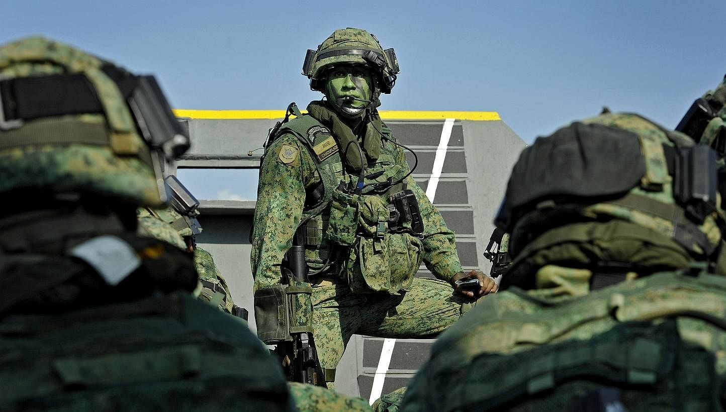 Servicemen from the Singapore Armed Forces (SAF) participating in a military exercise on Pulau Sudong on Aug 2, 2011.&nbsp;National Service stints may be shortened by a few weeks from the current two years, under a plan by the SAF to hire more career