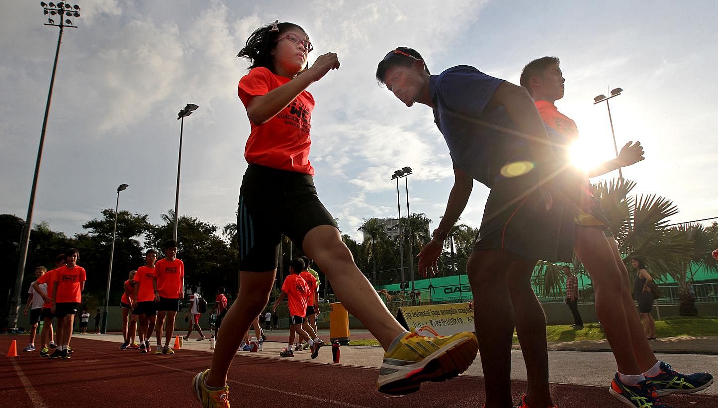 A primary school pupil trains with a coach, part of a growing trend as parents push their children to excel in sports so that they can enrol in a school through the Direct School Admission (DSA) programme.&nbsp;-- TNP FILE PHOTO:&nbsp;GAVIN FOO