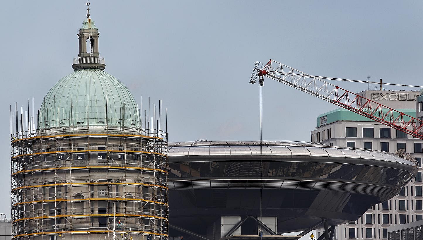 The Old Supreme Court Dome (left) being renovated, with the new supreme court in the background (right).&nbsp;The Old Supreme Court, along with City Hall, will become the National Art Gallery in 2015. -- ST FILE PHOTO: TED CHEN