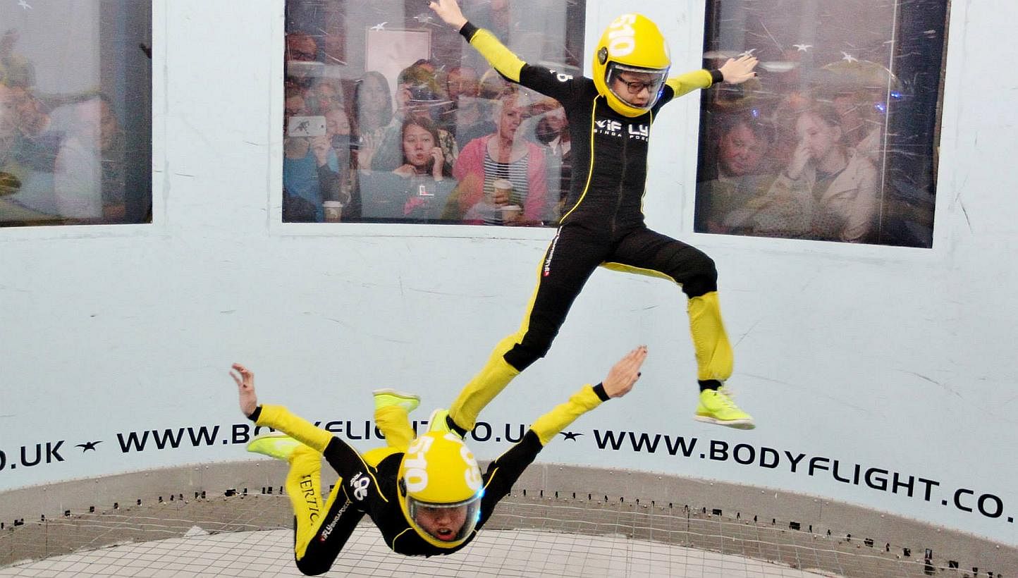Choo Yixuan, 12 (bottom), and Kyra Poh, 11, take part in the 2-way Free Fly Open at the Bodyflight World Challenge 2014.&nbsp;INDOOR skydivers from iFly Singapore made a strong debut at the two-day Bodyflight World Challenge event that concluded yest