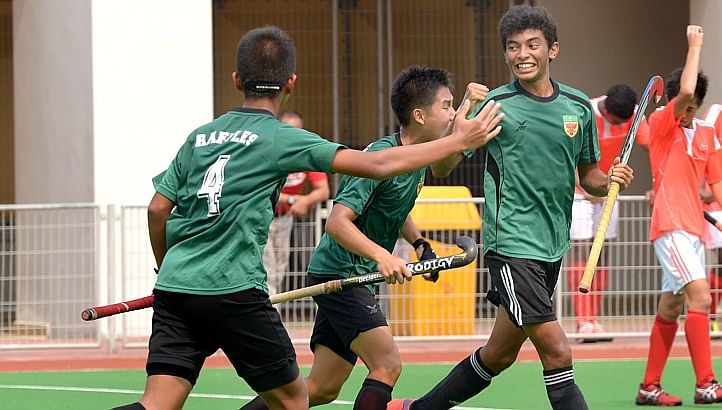 A Raffles Institution player (right) celebrates after scoring the first goal. -- ST PHOTO: LIM SIN THAI