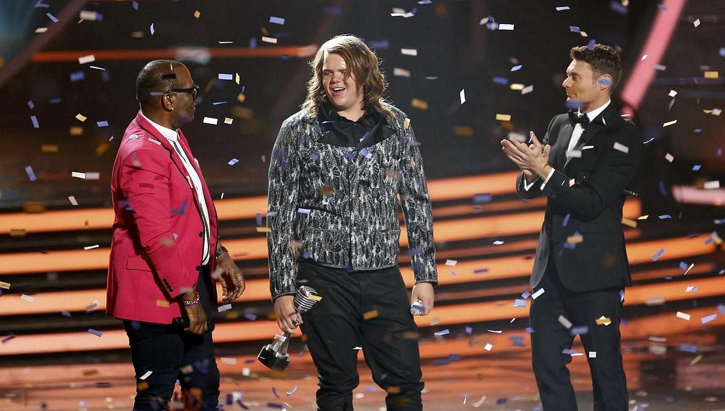 Randy Jackson (left) and show host Ryan Seacrest congratulate winner Caleb Johnson on stage during the American Idol XIII 2014 Finale in Los Angeles, California on May 21, 2014. -- PHOTO: REUTERS