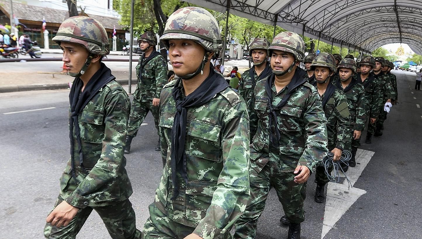 Soldiers march near the Government House after anti-government protesters were removed off the site following the coup being declared in Bangkok, Thailand on May 23, 2014. -- PHOTO: EPA