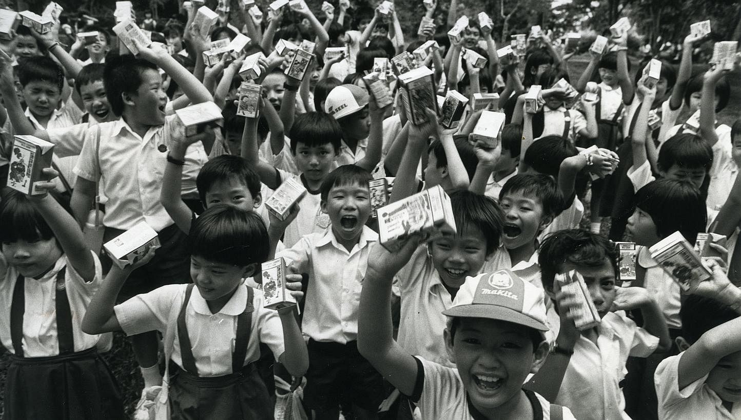 Children receive packets of milk as part of the annual Milk Day on Nov 19, 1985. -- PHOTO: ST FILE