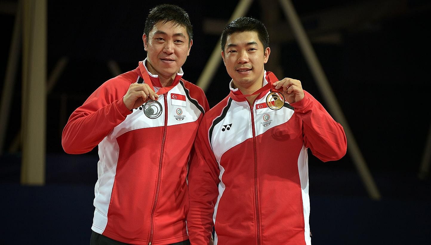 Singapore's Zhan Jian (right), seen here after winning the men's table tennis singles final against compatriot Gao Ning during the 2014 Glasgow Commonwealth Games, withdrew from the Asian Games squad with an injured right elbow. -- PHOTO: ST FILE&nbs