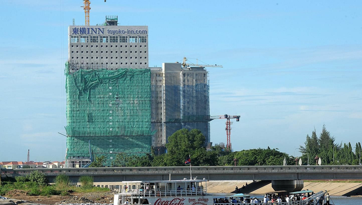 New buildings being constructed in Phnom Penh in August 2014. -- PHOTO: AFP