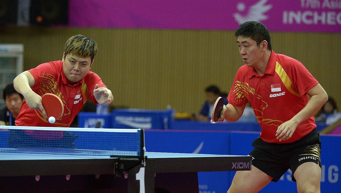 Singapore men's paddlers Gao Ning and Li Hu clinched the 12th bronze medal for Singapore at the Incheon Asian Games on Friday, despite losing their men's doubles semi-final match against China's Xu Xin and Fan Zhendong. -- ST PHOTO: DESMOND WEE&nbsp;