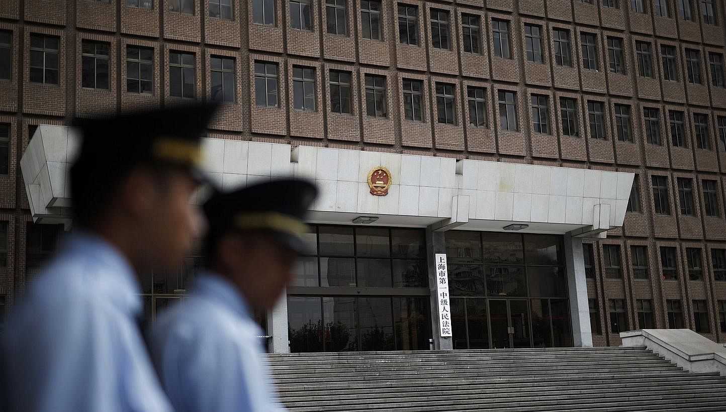 Police patrol outside the Shanghai No.1 Intermediate People's Court in Shanghai on Aug 8, 2014.&nbsp;The Chinese government is looking into abolishing the death penalty for nine of the 55 crimes that are currently punishable by death, state news agen