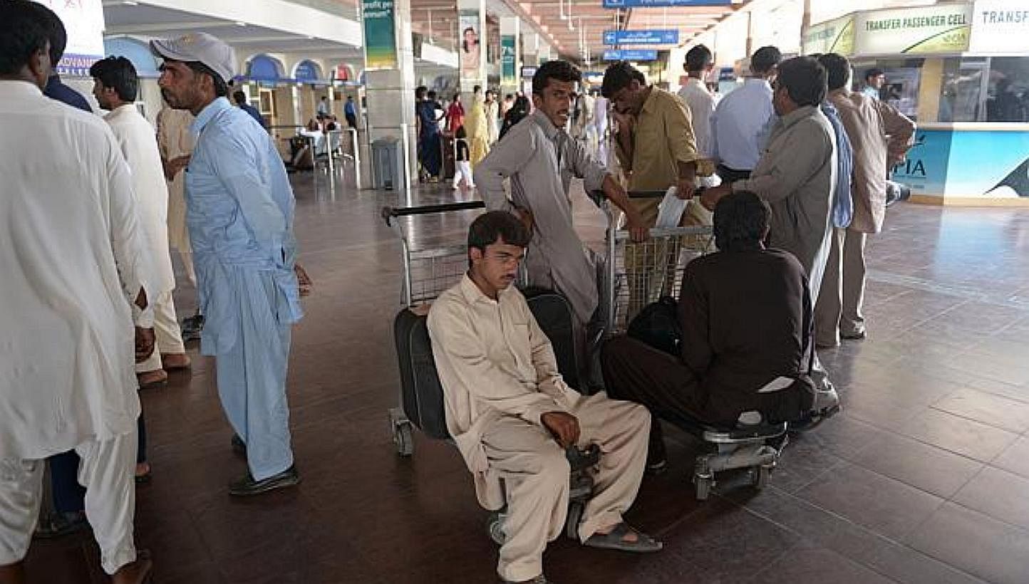 Passengers waiting at the Benazir Bhutto International Airport in Islamabad, Pakistan on Jun 9, 2014. -- PHOTO: AFP