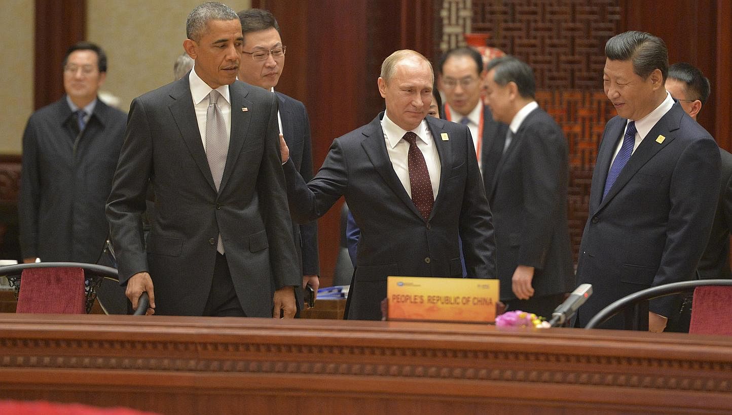 (From left) US President Barack Obama, Russian President Vladimir Putin and Chinese President Xi Jinping attend a plenary session during the Asia Pacific Economic Cooperation Summit in Beijing, on Nov 11, 2014. -- PHOTO: REUTERS
