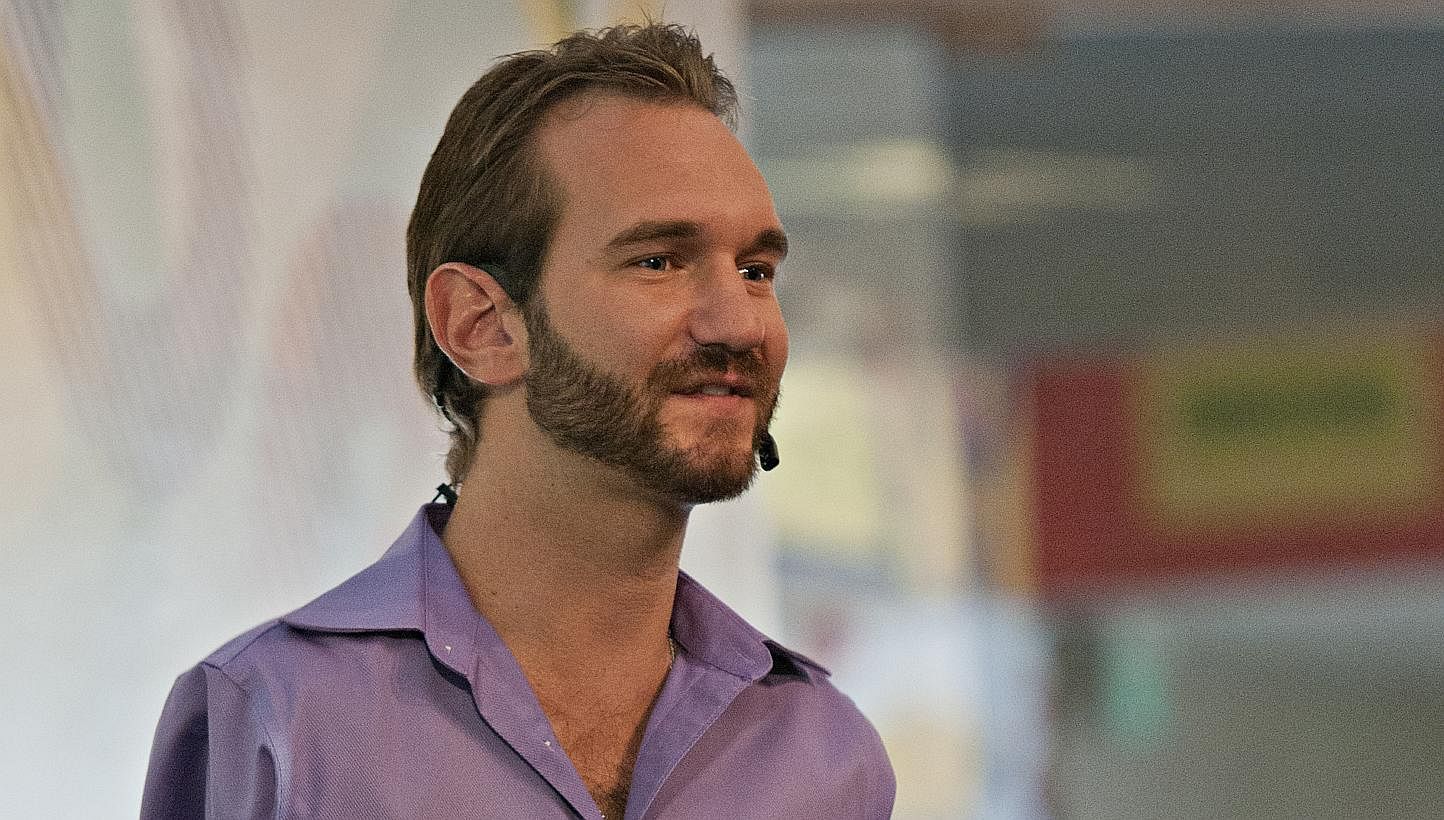Motivational speaker Nick Vujicic (above) may not be able to hold his son Kiyoshi, but he tries to be the best father he can be, so the boy will hug him. -- PHOTO: EDDY WEE