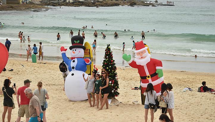 Visitors on Bondi Beach in Sydney on Christmas Day. Swimmers were ordered out of the water and the beach was closed briefly on Jan 2, 2015, after a shark was spotted. -- PHOTO: AFP
