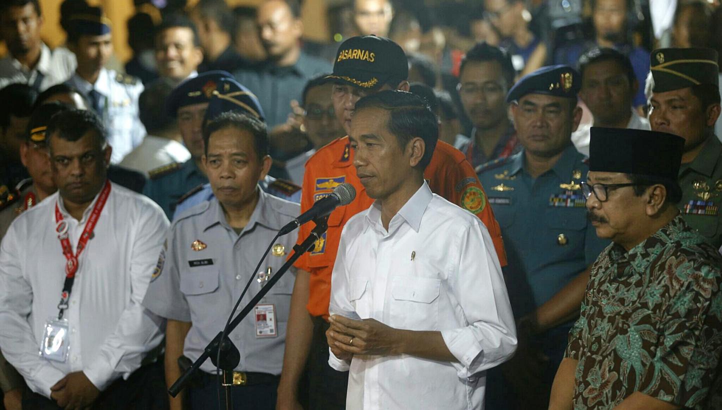 Indonesian president Joko Widodo speaks to the media after arriving at the crisis centre at Juanda International Airport Terminal 2 in Surabaya to meet with grieving family members on Dec 30, 2014. -- ST PHOTO: KEVIN LIM