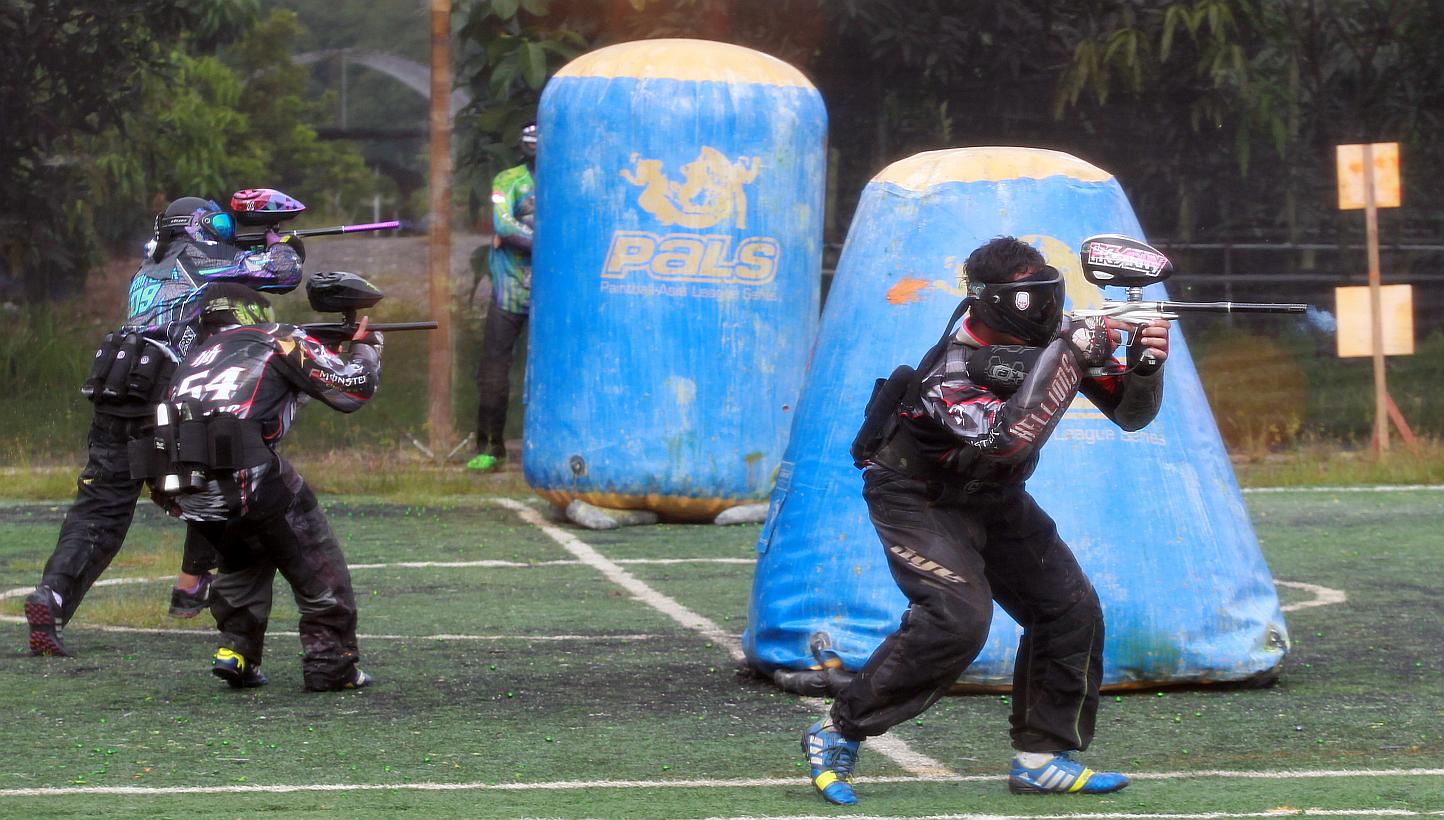 A group of people engaging in a paintball game in Singapore. Some 10,000 people from around the world have applied to be shot at as a paintball bullet tester for a British company. -- PHOTO: ST FILE&nbsp;