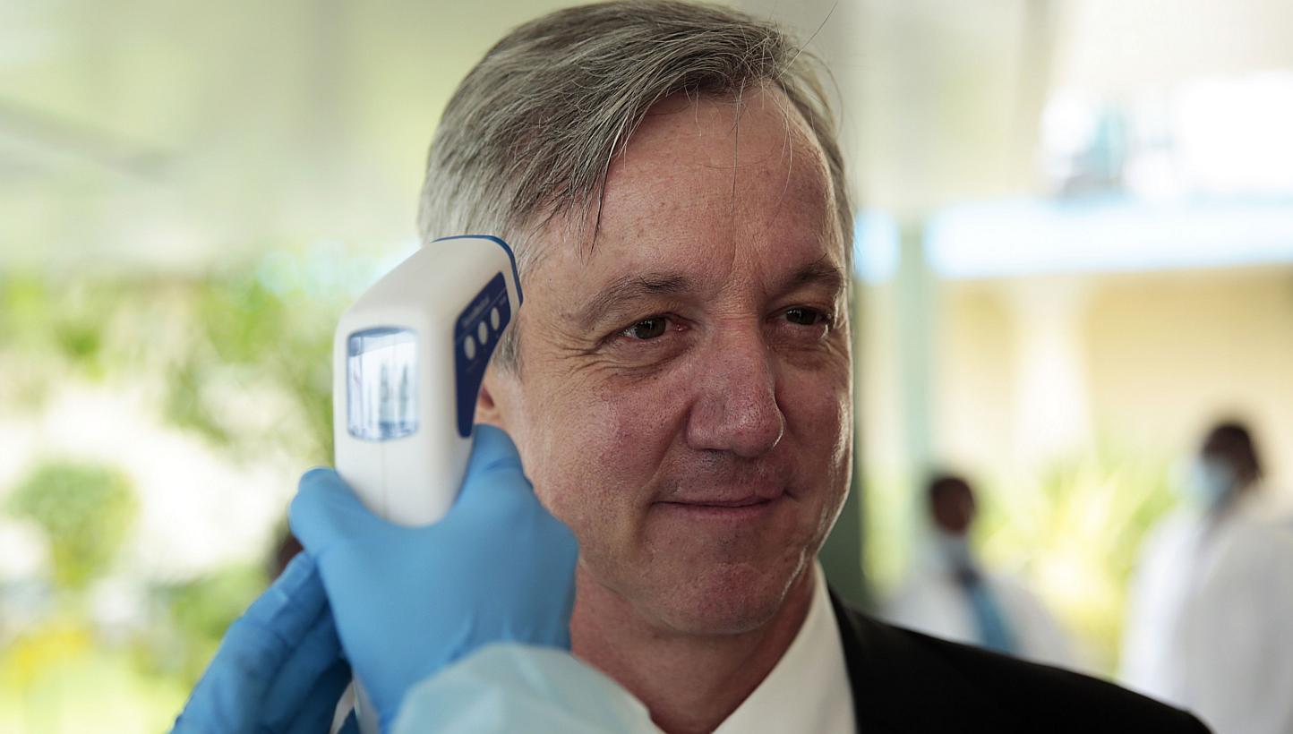 Outgoing Unmeer head Anthony Banbury getting his temperature measured during a visit to an Ebola medical unit on Dec 19, 2014. Mr Banbury said on Friday that the&nbsp;world can stamp out the Ebola outbreak in West Africa by the end of the year but mo