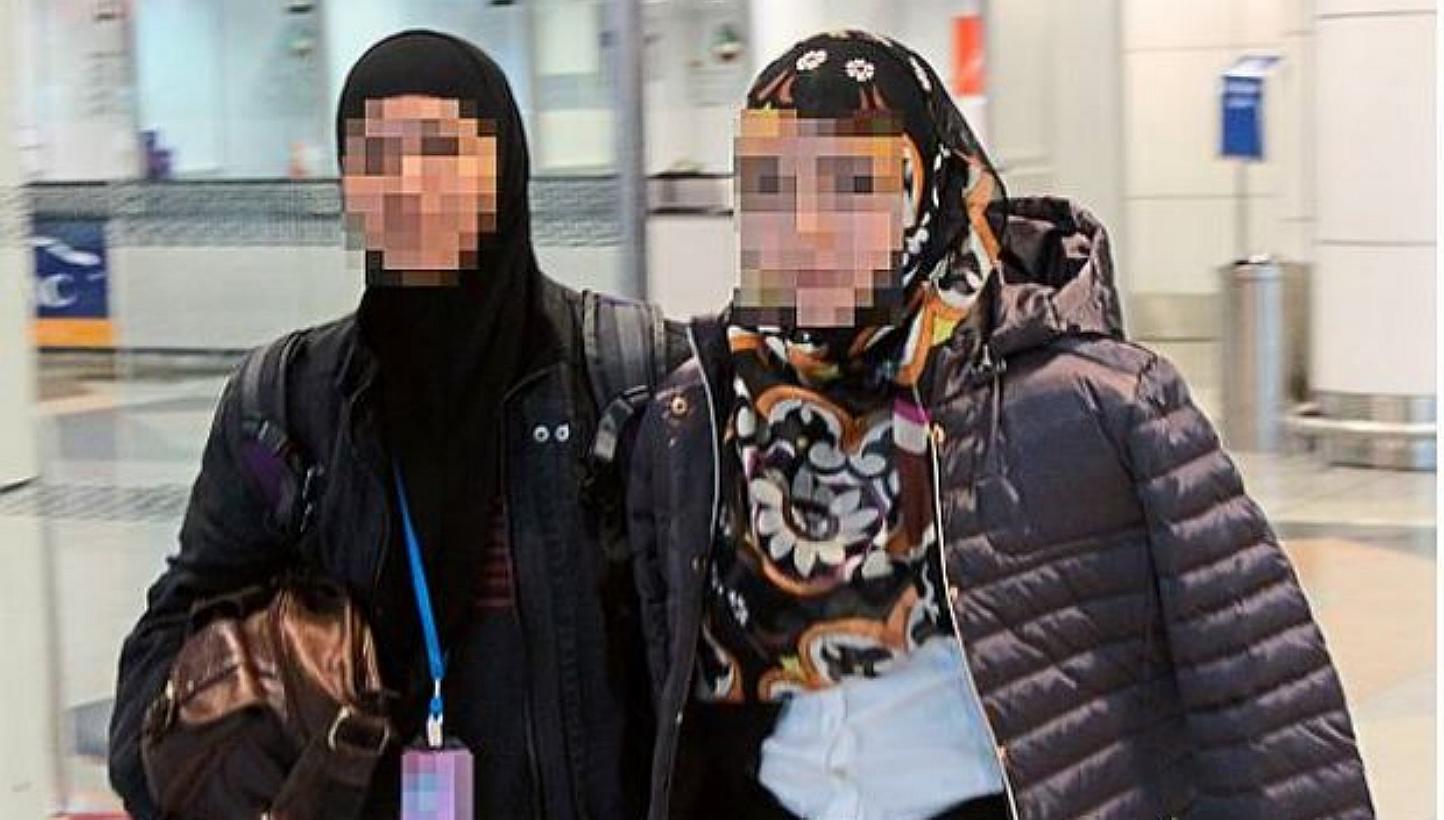 A woman officer (left) from the Bukit Aman Special Branch Counter-Terrorism Division is seen escorting the 27-year-old university dropout . -- PHOTO: THE STAR/ASIA NEWS NETWORK