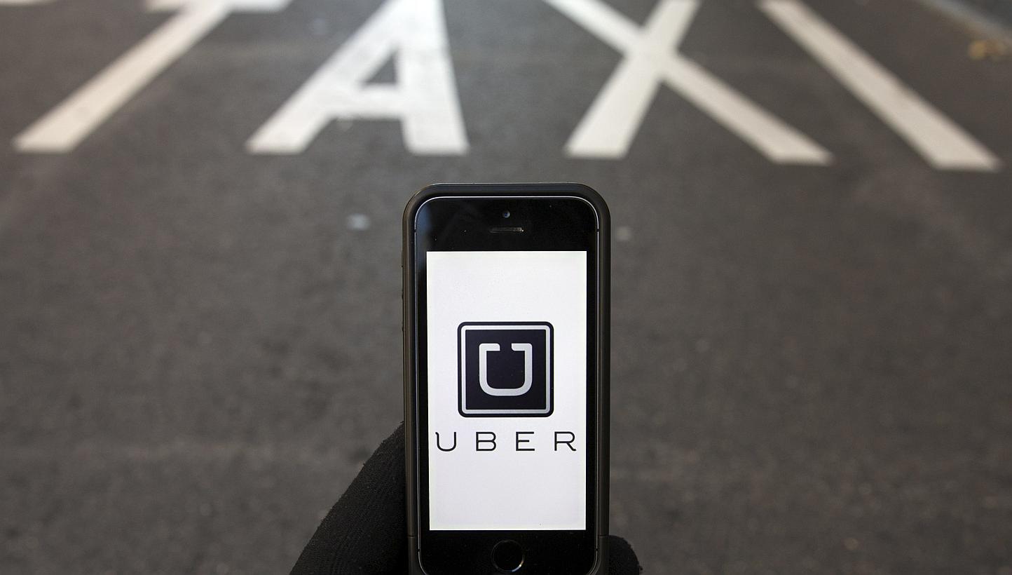 The logo of car-sharing service app Uber is seen in this photo illustration taken in Madrid on Dec 10, 2014. -- PHOTO: REUTERS 