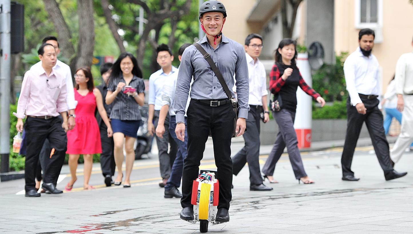 Mr Rick Tan, 43, takes 20 minutes to ride his electric unicycle from his home in Boon Keng to his office in Beach Road. -- PHOTO: LIM YAOHUI FOR THE SUNDAY TIMES