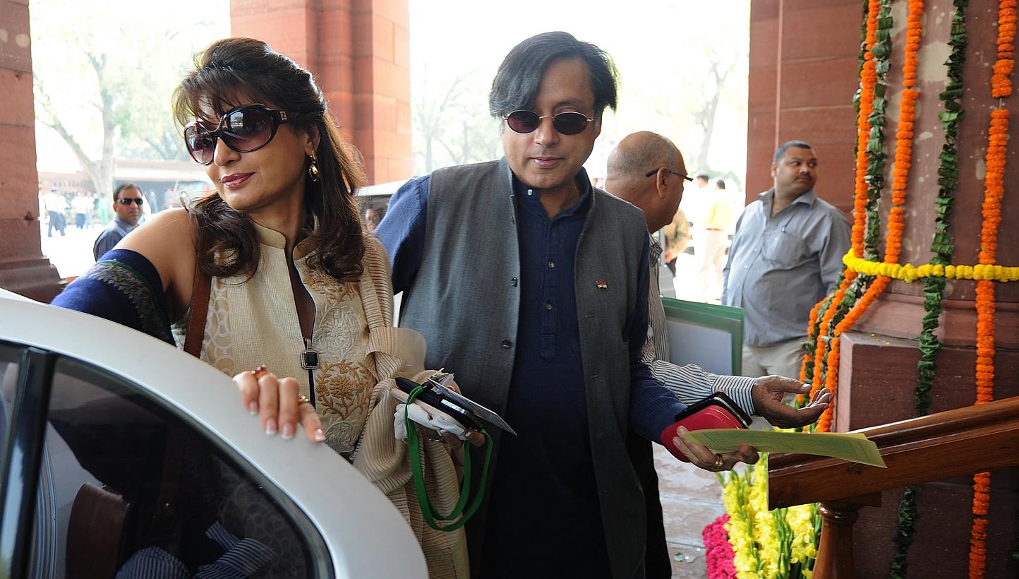 In this file photo, former Indian federal minister Shashi Tharoor (right) is seen arriving with his wife Sunanda Pushkar at parliament for the opening of the budget session in New Delhi on March 12, 2012. -- PHOTO: AFP 