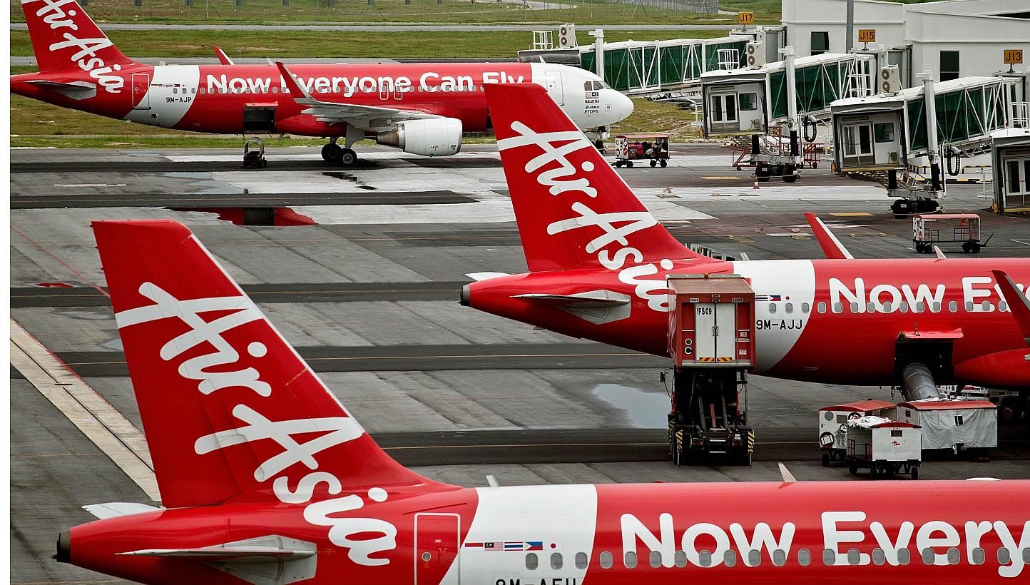 Three more weekly flights operated by Indonesia AirAsia to Singapore have been cancelled amid an official probe by the Indonesian authorities into the airline's flying permits. -- PHOTO: AFP