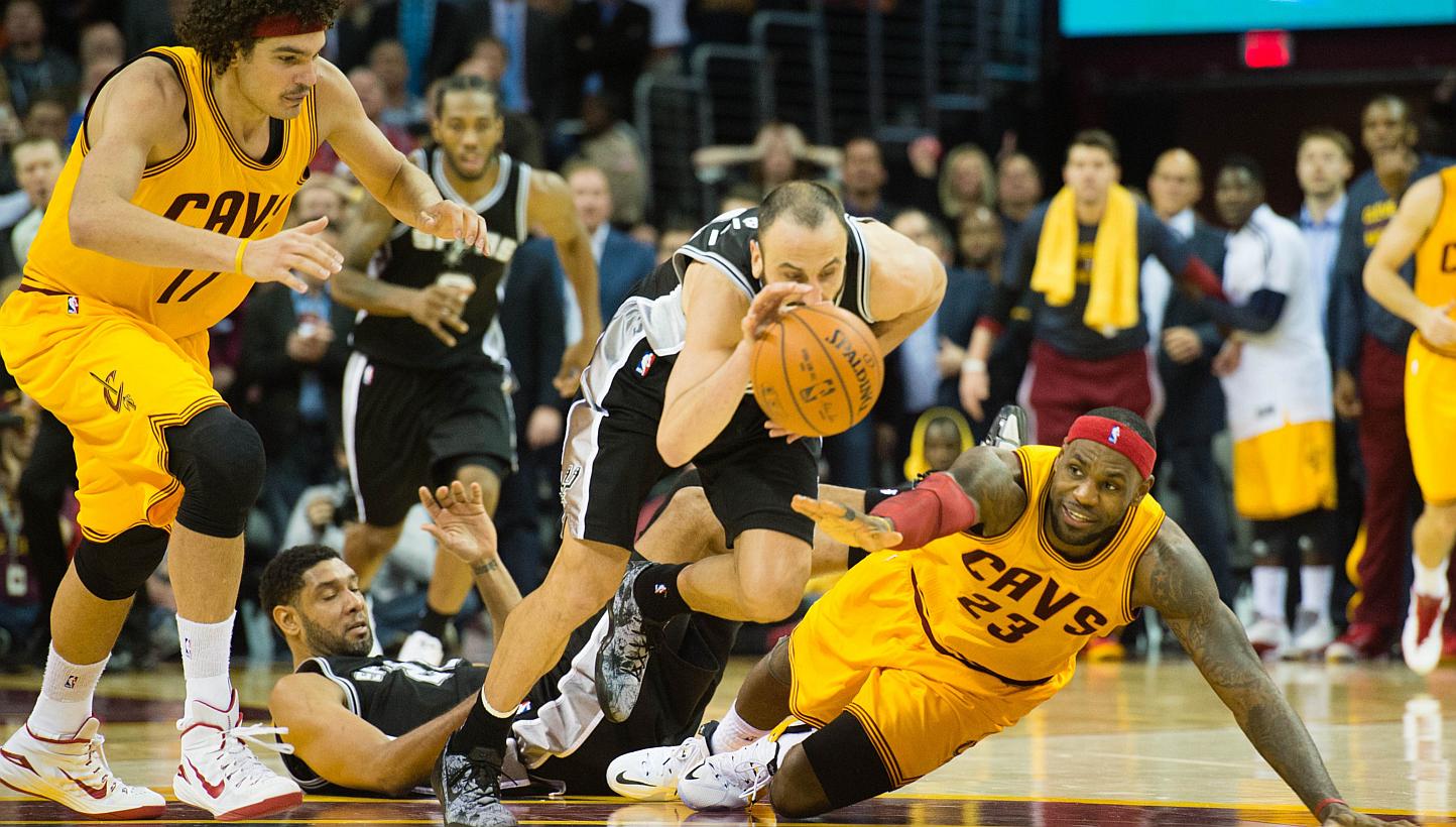 Manu Ginobili (#20) of the San Antonio Spurs steals the ball from LeBron James (#23) of the Cleveland Cavaliers during final seconds of the second half at Quicken Loans Arena on Nov 19, 2014 in Cleveland, Ohio. The Cavaliers are no longer favoured to