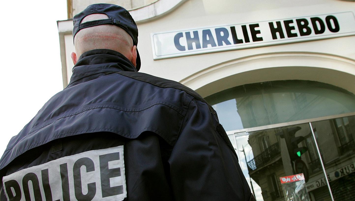 A policeman stands guard outside the French satirical weekly "Charlie Hebdo" in Paris in this Feb 9, 2006, file photo.&nbsp;The massacre on Wednesday at French weekly Charlie Hebdo took place after years of confrontation between the satirical publica