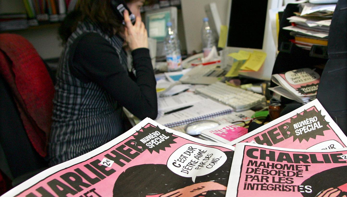 A journalist works in the Paris newsroom of French satirical weekly Charlie Hebdo, in this Feb 9, 2006, file photo. -- PHOTO: REUTERS