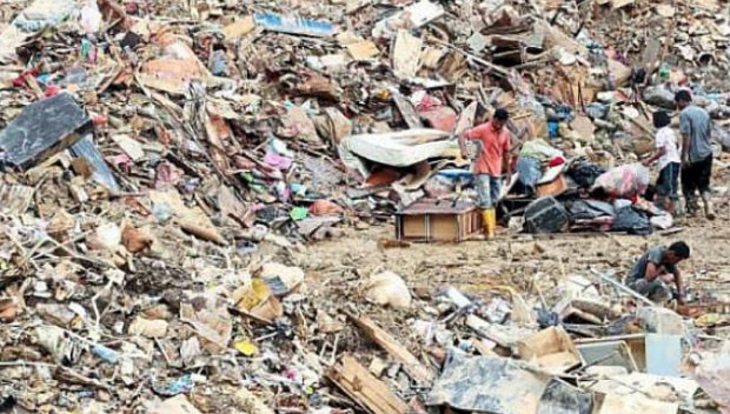 Villagers salvaging useful items from flood trash at an unregistered disposal site in Kuala Krai, Kelantan. -- PHOTO: THE STAR/ASIA NEWS NETWORK
