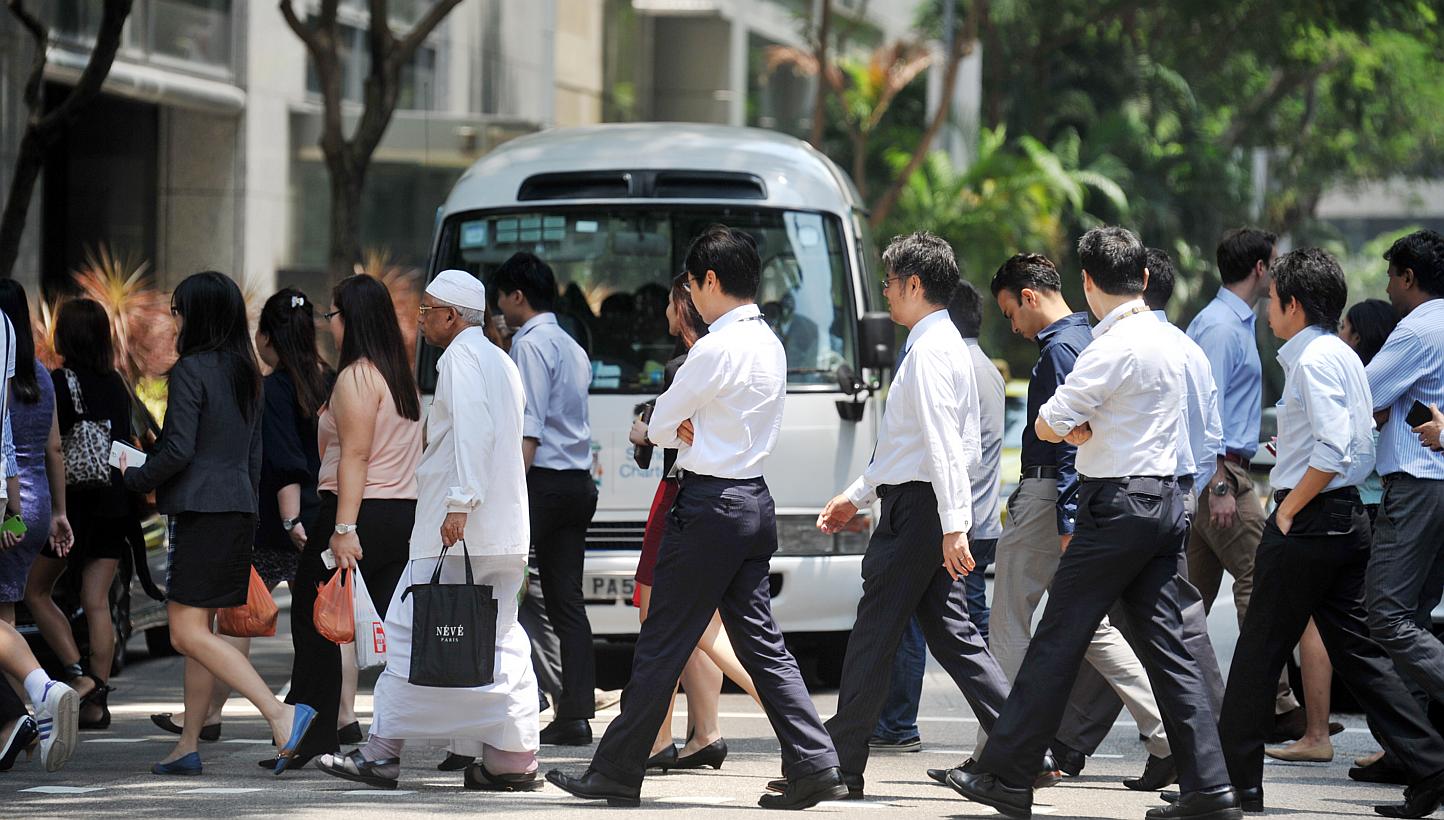 Office workers crossing the road at Market Street in Tanjong Pagar on Sept 8, 2014. -- PHOTO: ST FILE