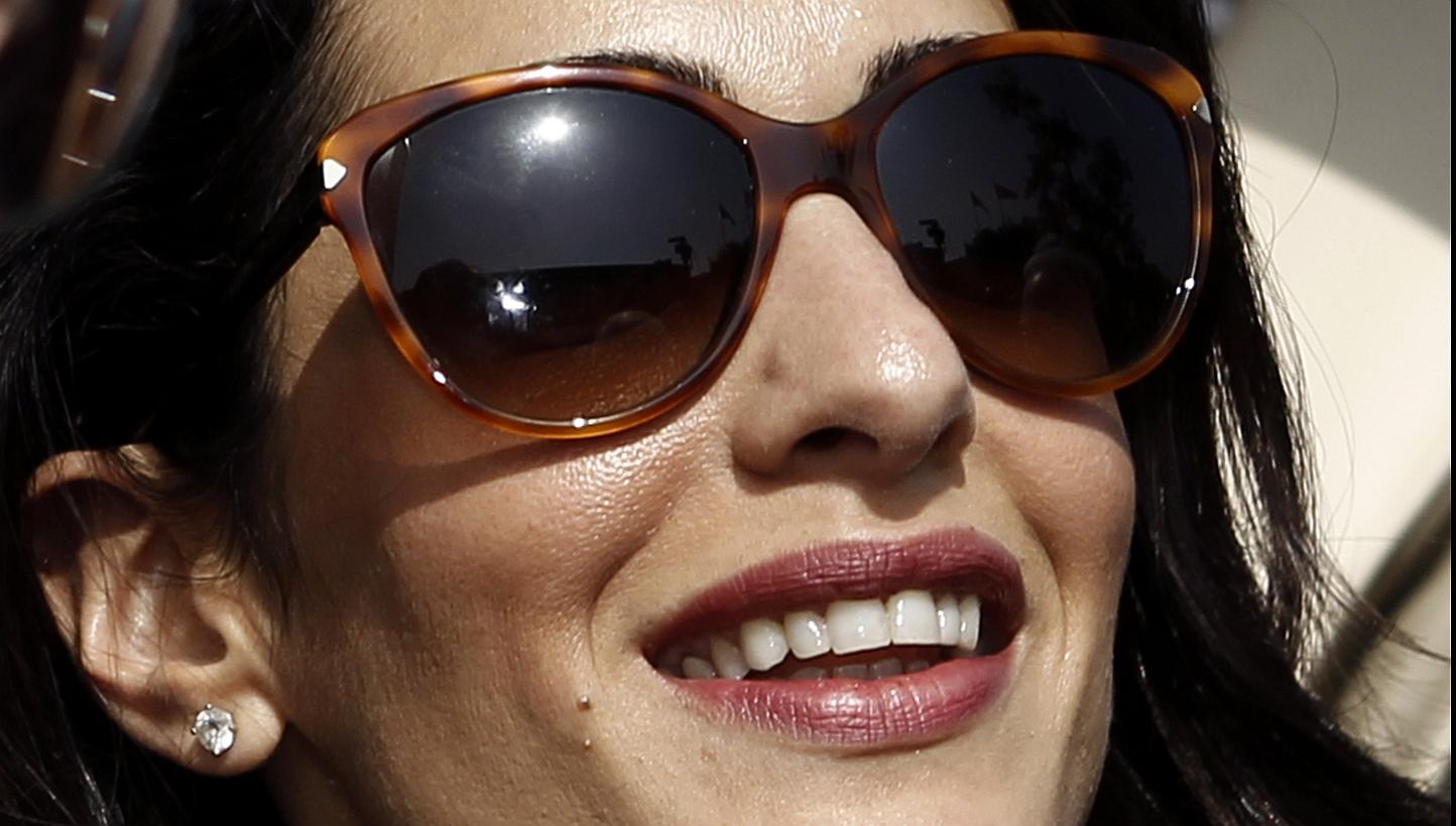 Human rights lawyer Amal Alamuddin Clooney is disputing a story reporting how Egyptian officials warned her that she risked arrest last year if she released a report in Cairo critical of the judiciary. -- PHOTO: REUTERS