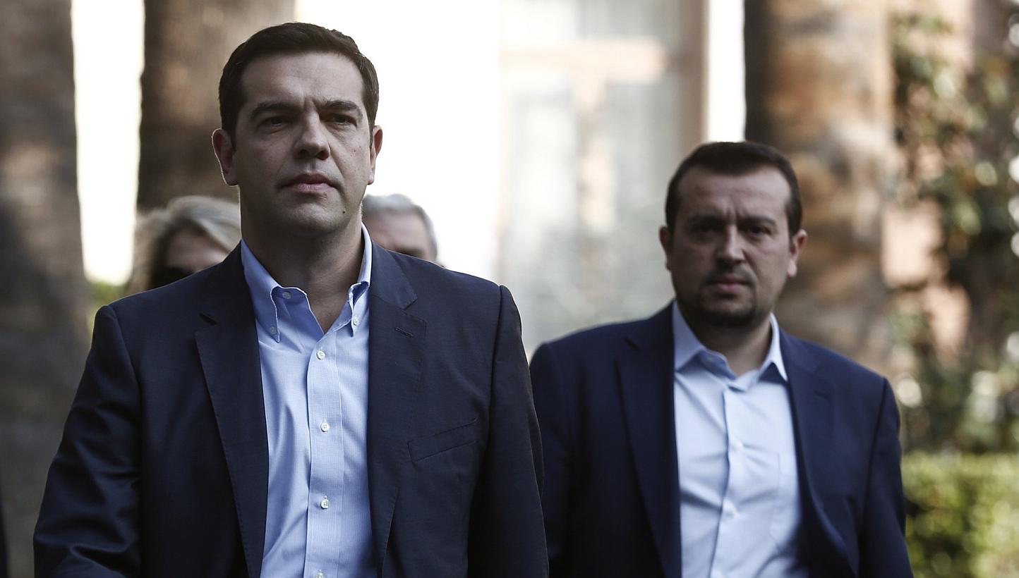 Alexis Tsipras (centre), leader of Greece's far-left Syriza party, leaves the Presidential palace in Athens in this file photo. The first sign of obvious trouble could come from Greece, where the populist left-leaning Syriza could win a snap election