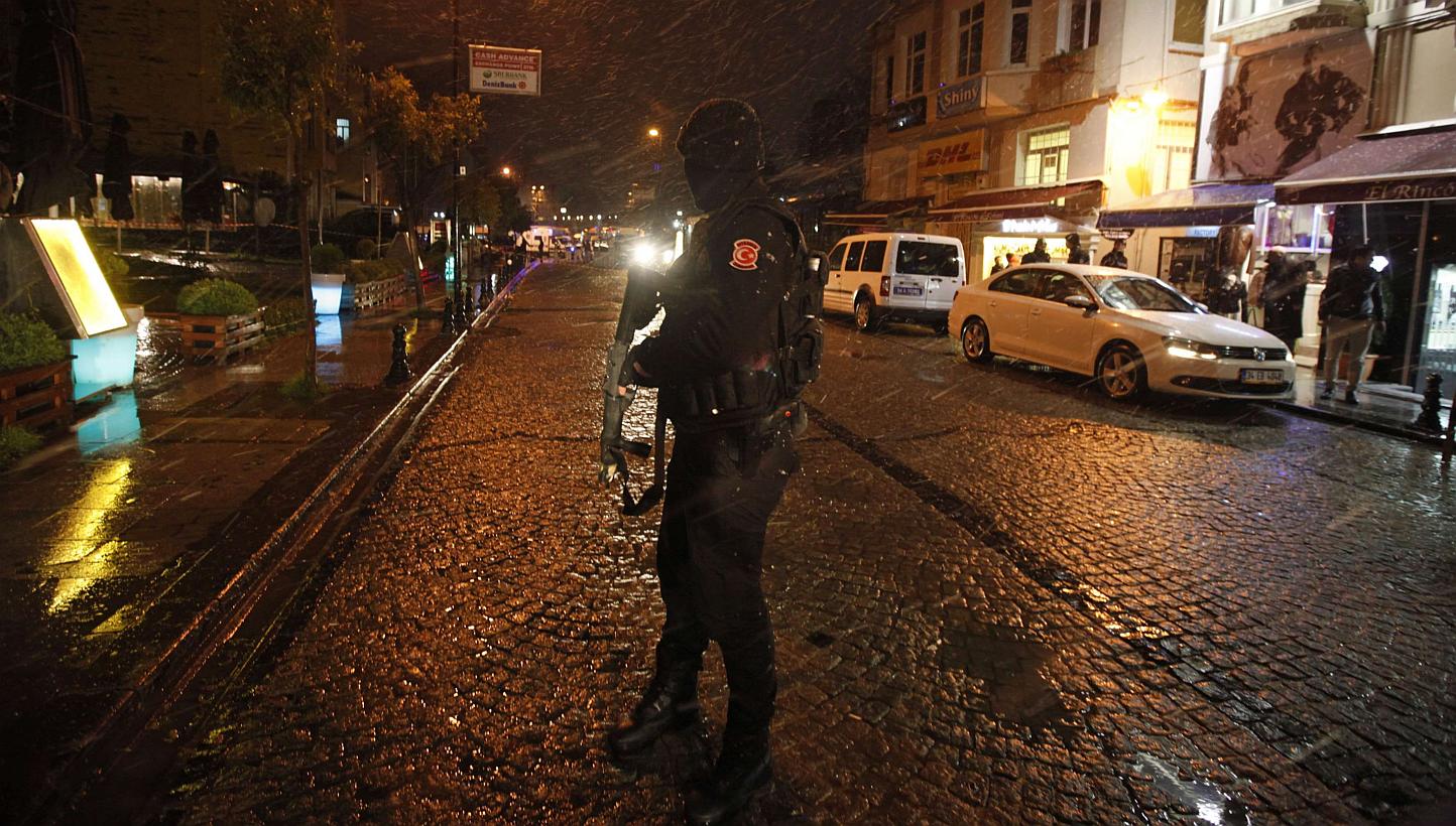 A police officer stands guard at the scene of a bomb blast in Istanbul Jan 6, 2015. An outlawed Turkish Marxist group on Wednesday claimed a strike by a female suicide bomber in the heart of Istanbul's tourist district, raising fears of a wave o