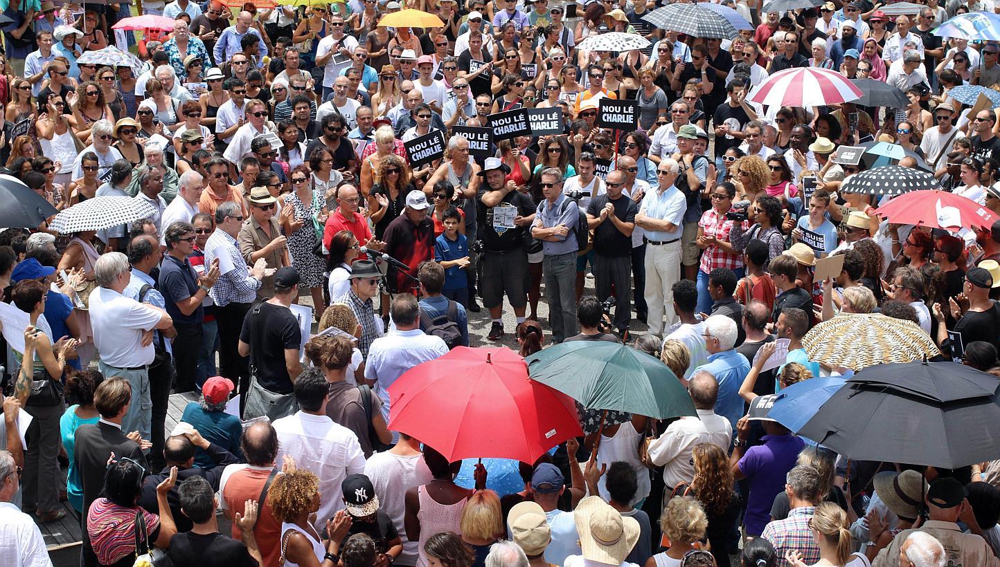 Hundreds of people gather on the Human Rights square in Saint-Denis de la Reunion on Jan 8, 2015, in tribute to the twelve people killed the day before in an attack by two armed gunmen on the offices of French satirical newspaper Charlie Hebdo in Par