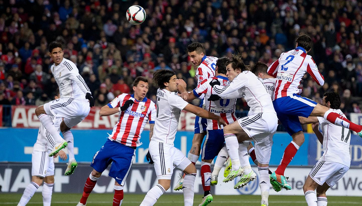 Atletico Madrid's Uruguayan defender Jose Gimenez (centre) heading to score during the Spanish Copa del Rey round of 16 first leg football match against Real Madrid at the Vicente Caldero on Jan 7, 2015. -- PHOTO: AFP