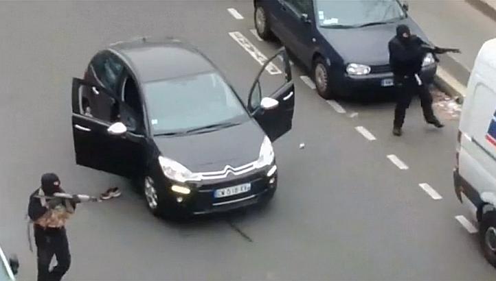 Gunmen fleeing the offices of French satirical newspaper Charlie Hebdo in Paris, in this still image taken from amateur video shot on Jan 7, 2015, and obtained by Reuters. -- PHOTO: REUTERS
