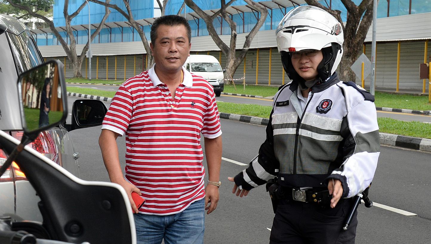 Caught - showing road courtesy, so hawker Lim Kan Seng received a reward instead of a summons. Traffic Police officers are on the lookout for good drivers - as well as bad ones.