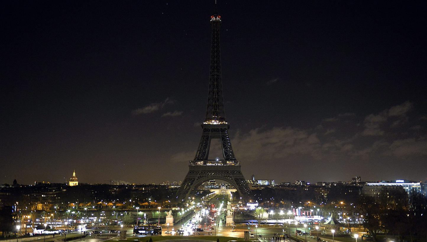 At 8pm on Jan 8, 2015, the Eiffel Tower lights were switched off for six minutes as a tribute to the victims of the Charlie Hebdo attack. -- PHOTO: REUTERS