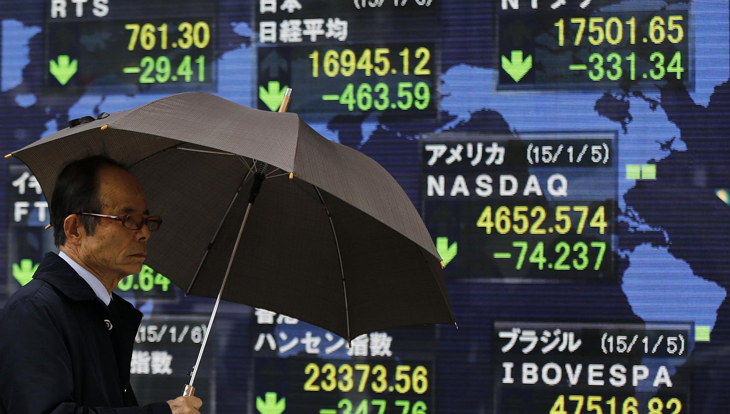 An electronic board displaying Japan's Nikkei average and various countries' stock price index outside a brokerage in Tokyo. Asian stocks gained on Friday on upbeat expectations for the closely-watched US jobs data. -- PHOTO: REUTERS