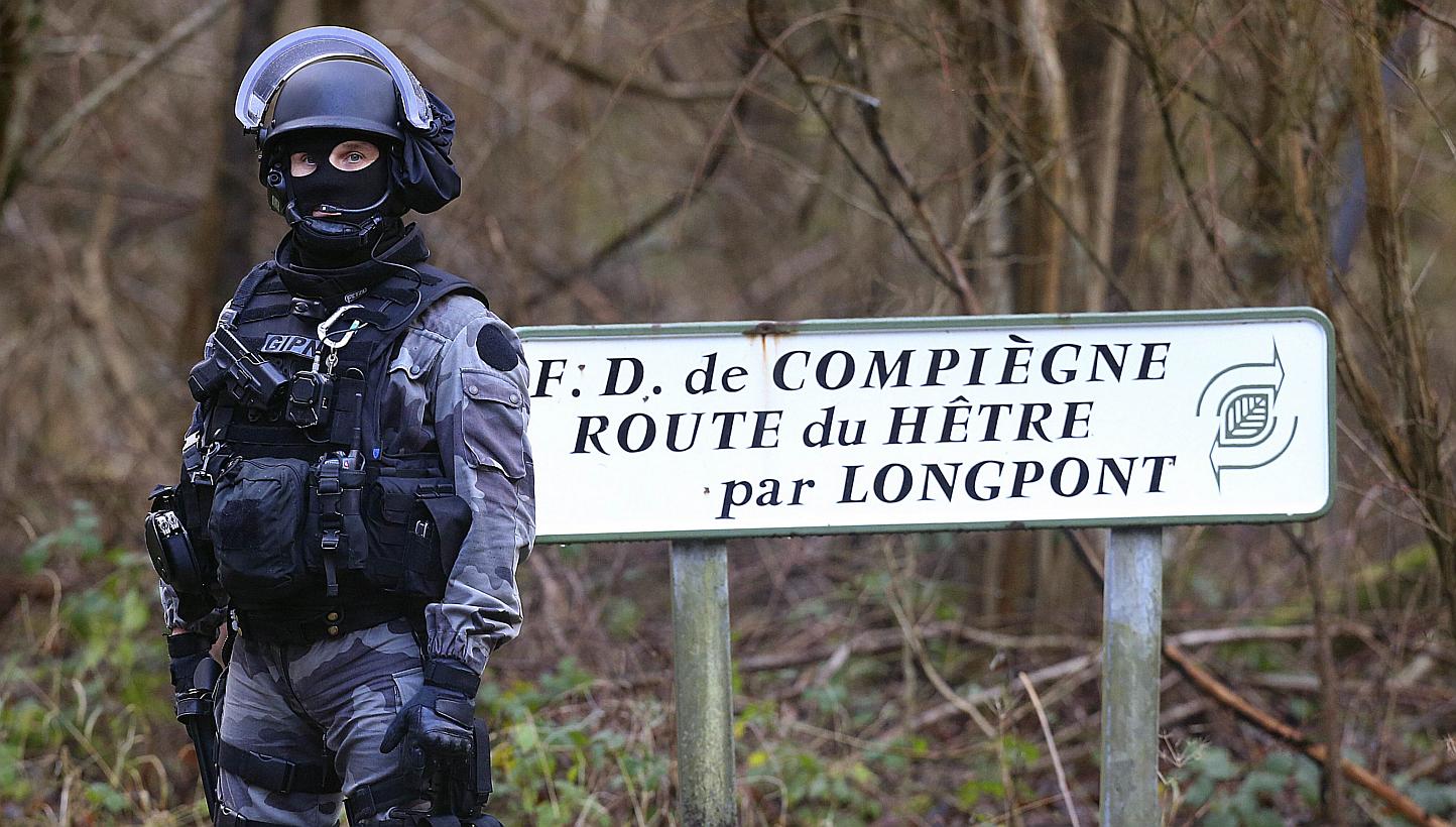 A member of GIPN, (French National Police Intervention Groups) is pictured in Corcy, near Villers-Cotterets, north-east of Paris, on Jan 8, 2015, where the two armed suspects from the attack on French satirical weekly newspaper Charlie Hebdo were spo