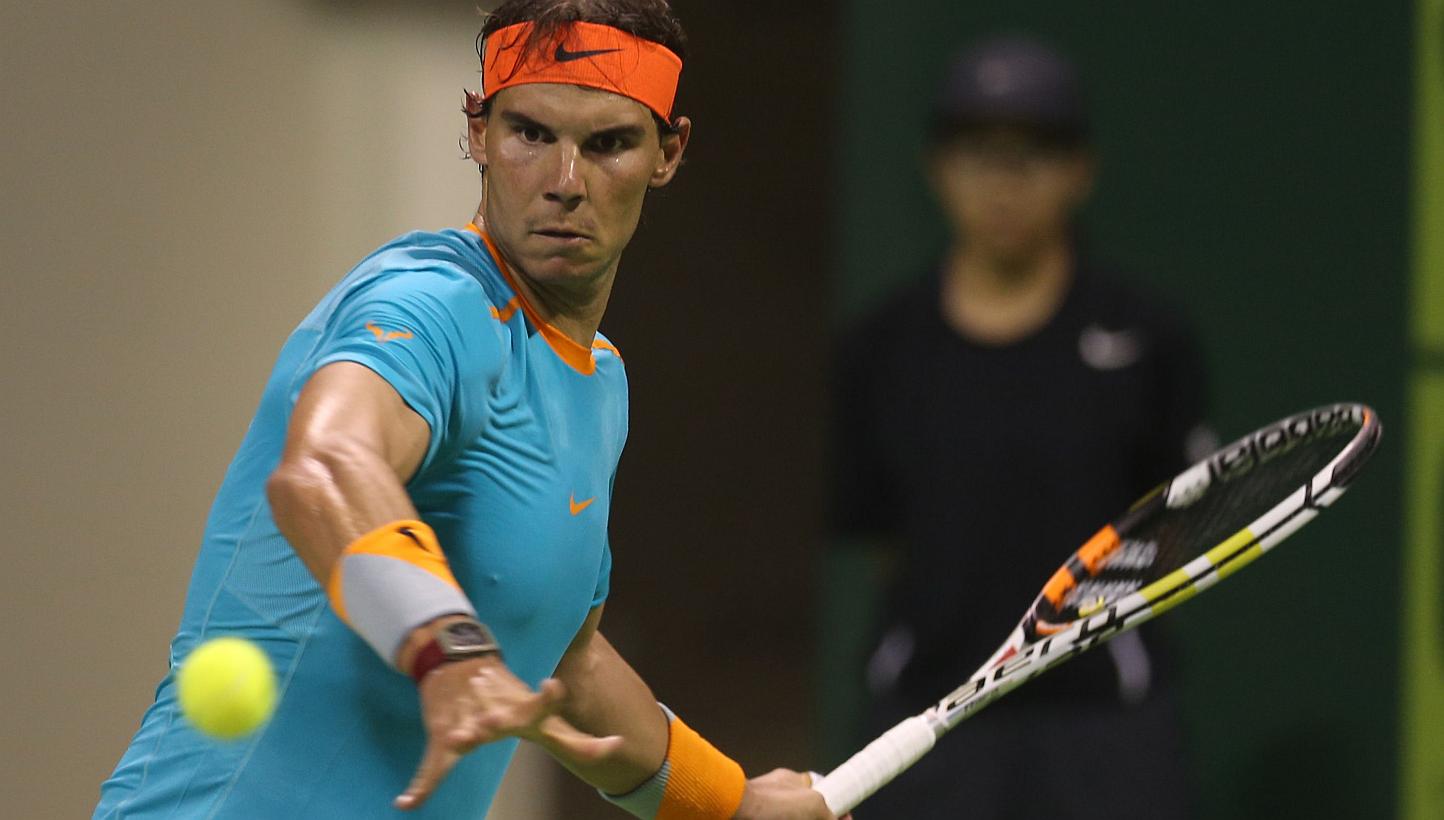 Spanish tennis player Rafael Nadal returns the ball to Michael Berrer of Germany during their tennis match in Qatar's ExxonMobil Open on Jan 6, 2015, in Doha. -- PHOTO: AFP&nbsp;